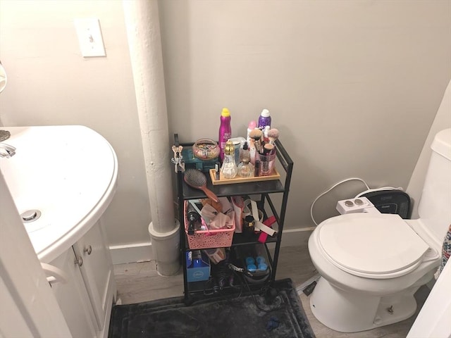 12-14 Essex St, Dover, NH 03820 - bathroom featuring toilet, baseboards, and vanity