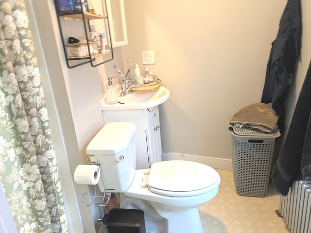 12-14 Essex St, Dover, NH 03820 - full bath with radiator, toilet, vanity, tile patterned floors, and curtained shower