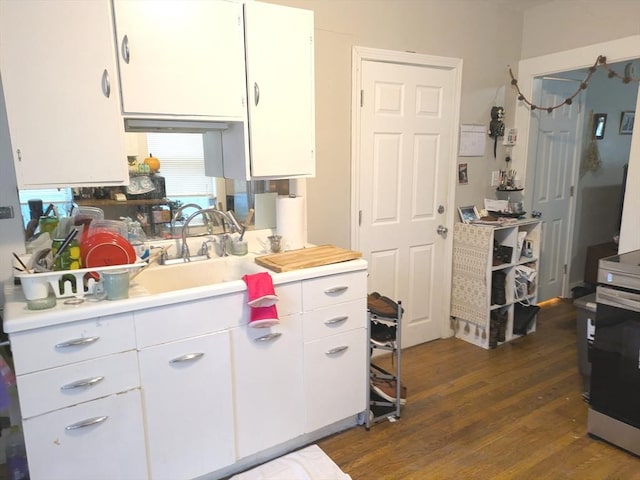 12-14 Essex St, Dover, NH 03820 - kitchen with light countertops, white cabinetry, dark wood-type flooring, and a sink