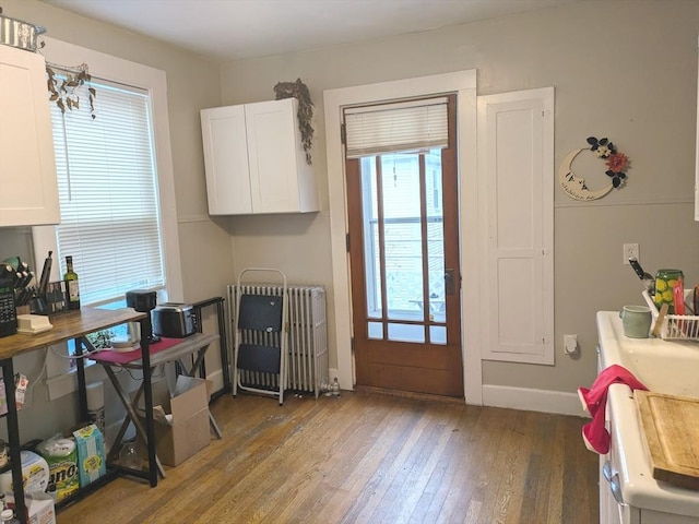 12-14 Essex St, Dover, NH 03820 - dining space featuring radiator, hardwood / wood-style flooring, healthy amount of natural light, and baseboards
