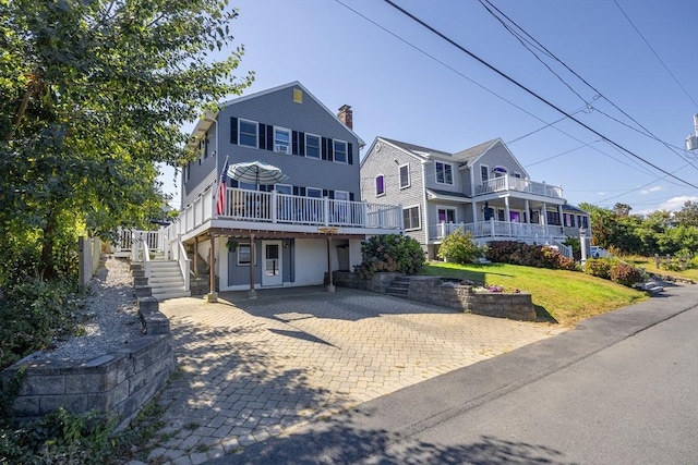 38 Point Allerton Ave, Hull, MA 02045 - view of front of property with stairs, a deck, a front yard, and driveway