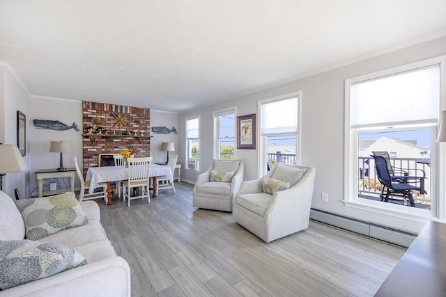 38 Point Allerton Ave, Hull, MA 02045 - living room with a baseboard heating unit, light wood-style flooring, crown molding, and a fireplace