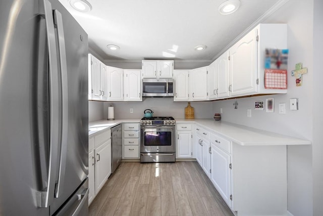 38 Point Allerton Ave, Hull, MA 02045 - kitchen featuring stainless steel appliances, light wood-type flooring, white cabinets, recessed lighting, and light countertops
