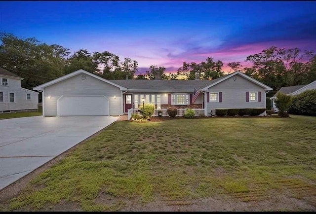 ranch-style home with a garage and a yard