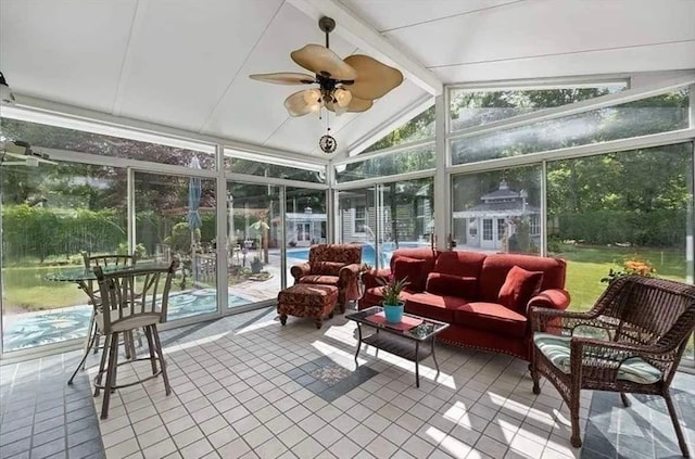 sunroom / solarium featuring ceiling fan and vaulted ceiling with beams