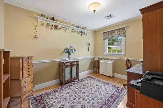 home office with hardwood / wood-style flooring and crown molding