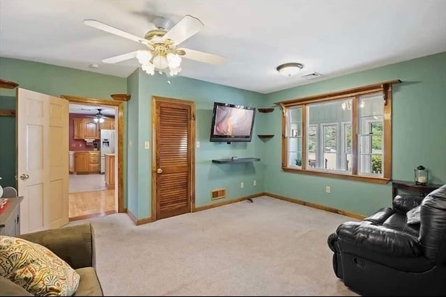 living room featuring carpet and ceiling fan