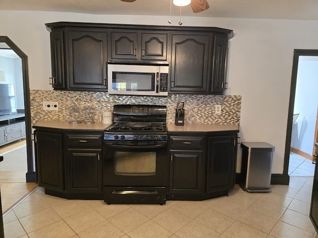 kitchen featuring tasteful backsplash, black range with gas stovetop, light tile patterned floors, and ceiling fan