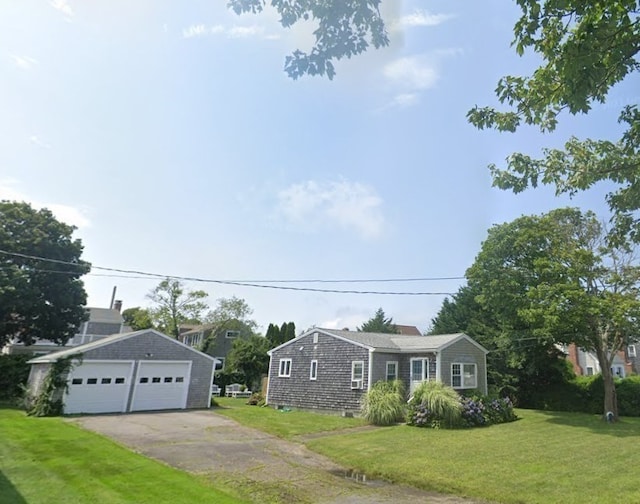 view of front of house featuring a garage and a front lawn