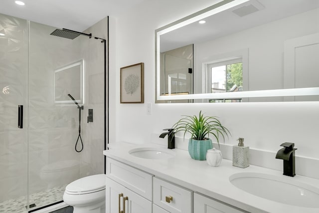 bathroom with vanity, toilet, and an enclosed shower