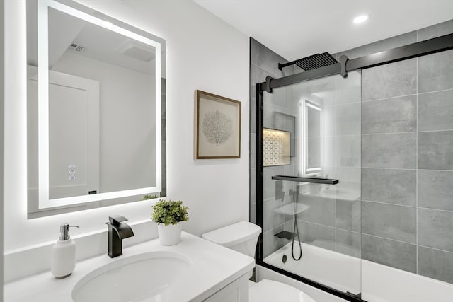 full bathroom featuring tiled shower / bath combo, vanity, and toilet