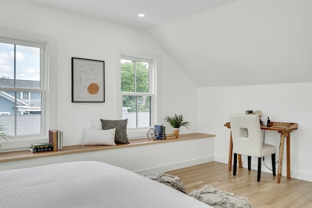 bedroom featuring lofted ceiling and light hardwood / wood-style floors