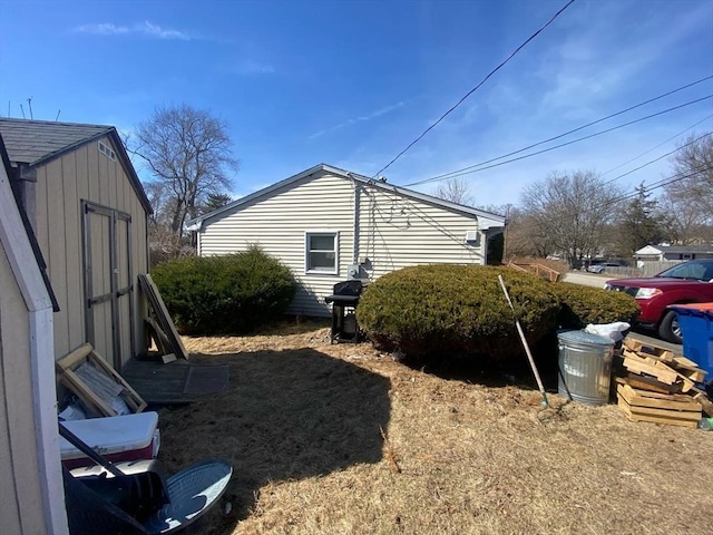 view of property exterior featuring an outbuilding and a storage shed