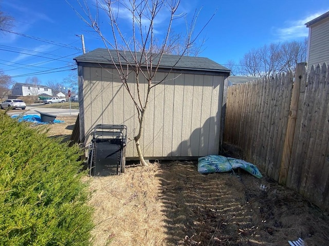 view of shed featuring fence