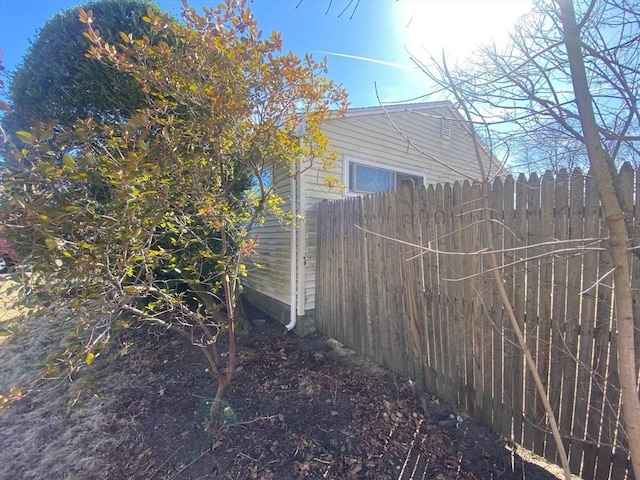 view of property exterior featuring fence