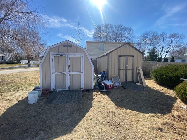 view of shed featuring fence
