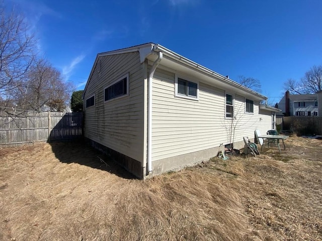 view of property exterior featuring fence