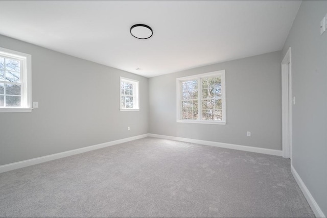 spare room with carpet flooring and baseboards