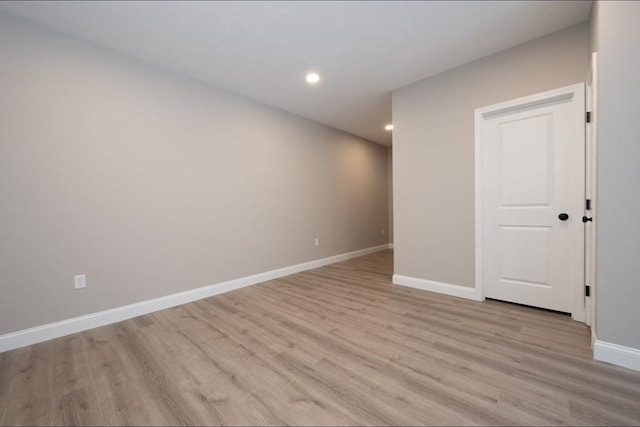 unfurnished room with recessed lighting, light wood-style flooring, and baseboards