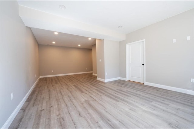 unfurnished room with recessed lighting, wood finished floors, and baseboards