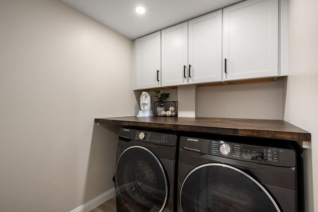 laundry area featuring wood finished floors, baseboards, recessed lighting, cabinet space, and independent washer and dryer