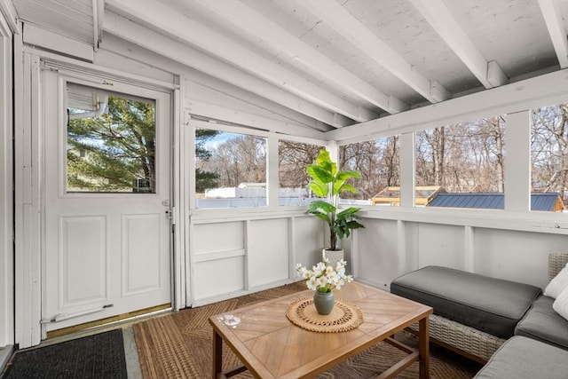 sunroom / solarium featuring vaulted ceiling