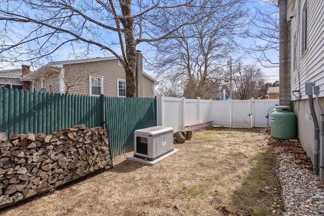 view of yard featuring a fenced backyard and a gate