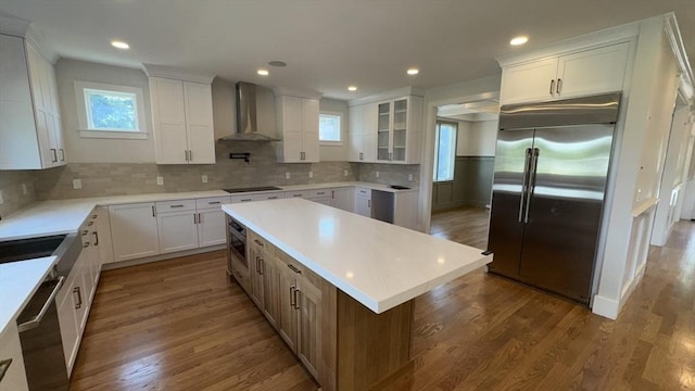 7 Avery St, Needham, MA 02494 - kitchen with stainless steel appliances, wall chimney range hood, white cabinets, backsplash, and recessed lighting