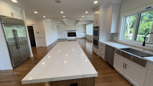 7 Avery St, Needham, MA 02494 - kitchen featuring stainless steel appliances, a sink, a large island, white cabinetry, and dark wood-type flooring