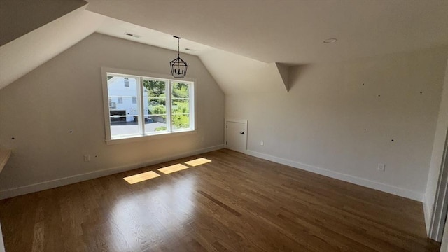 7 Avery St, Needham, MA 02494 - additional living space with vaulted ceiling, baseboards, and wood finished floors