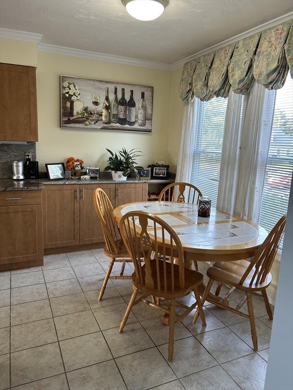 38 Bay Pointe Dr Unit 38, Wareham, MA 02532 - dining area featuring ornamental molding, healthy amount of natural light, and light tile patterned floors