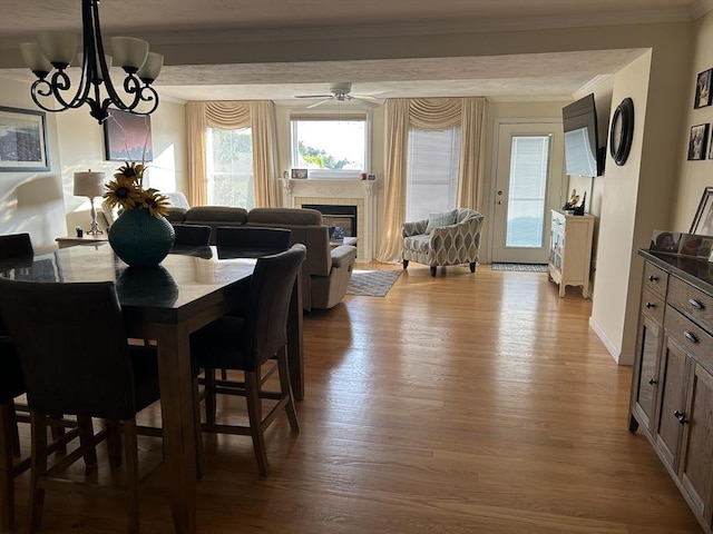 38 Bay Pointe Dr Unit 38, Wareham, MA 02532 - dining space with wood finished floors, a fireplace, ornamental molding, and a chandelier
