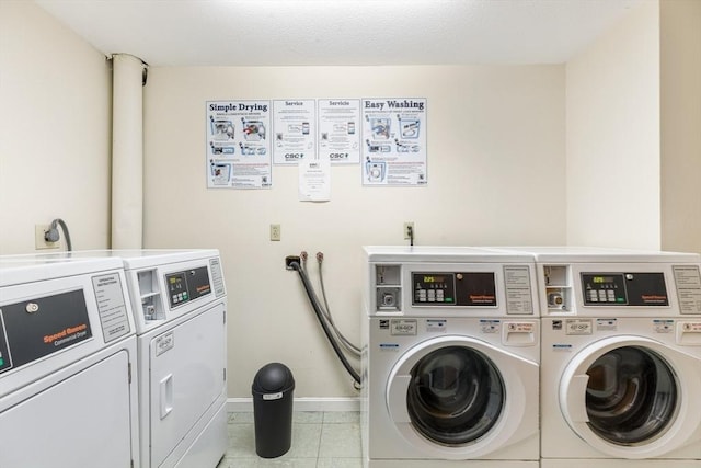 laundry area featuring light tile patterned floors and independent washer and dryer