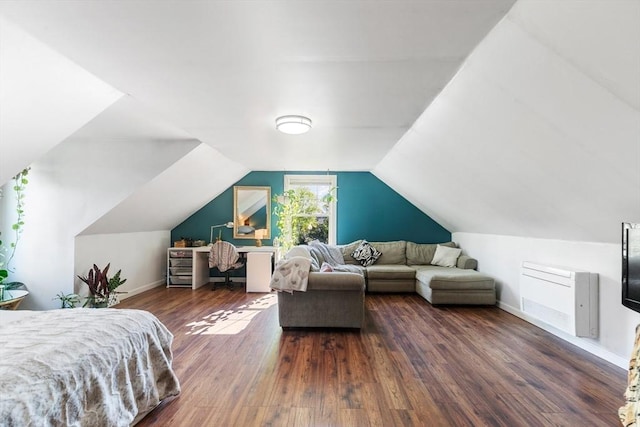 bedroom featuring wood finished floors, baseboards, and lofted ceiling