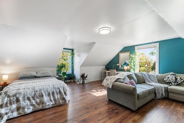 bedroom featuring vaulted ceiling, wood finished floors, and baseboards