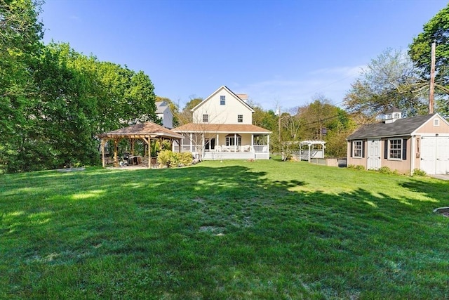 back of house featuring a gazebo, a lawn, a shed, an outbuilding, and covered porch