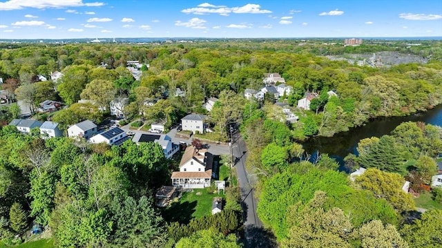 aerial overview of property's location featuring a heavily wooded area and a large body of water