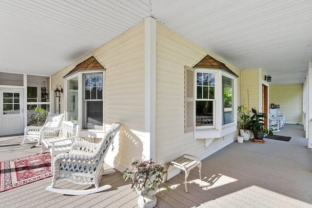 wooden terrace featuring covered porch