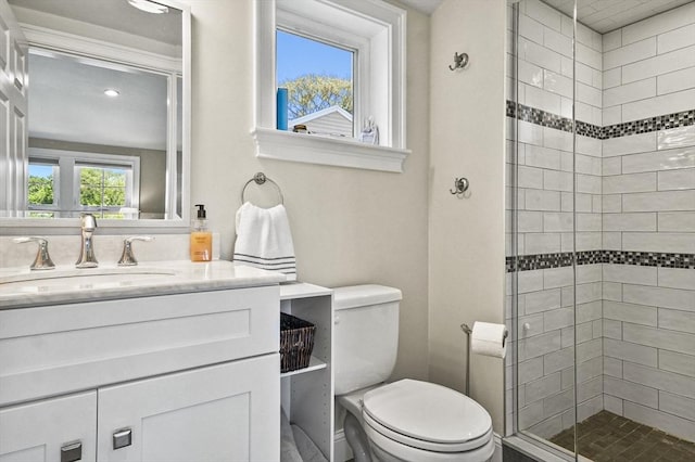 full bathroom featuring toilet, a stall shower, and vanity