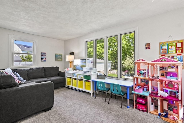 rec room with plenty of natural light, carpet flooring, and a textured ceiling