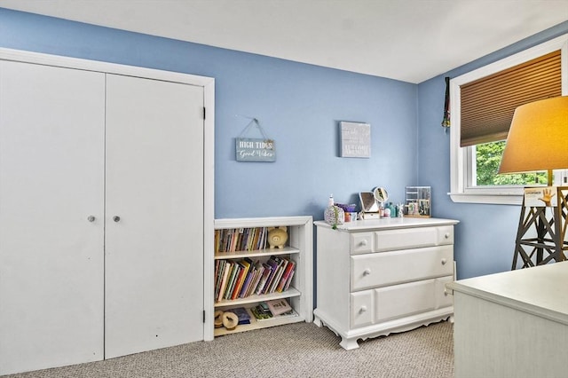 bedroom with carpet and a closet