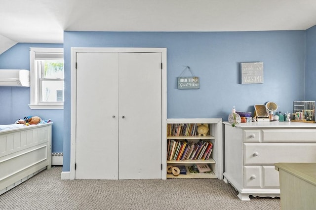 carpeted bedroom with a wall mounted air conditioner and a closet
