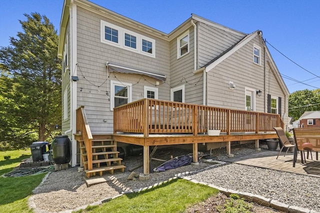 rear view of house with a wooden deck and a patio area