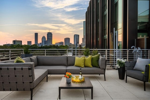 balcony with a view of city and an outdoor hangout area