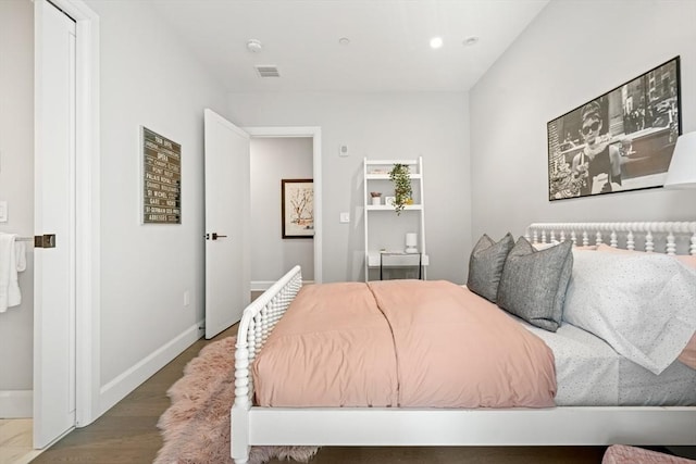 bedroom featuring visible vents, wood finished floors, and baseboards