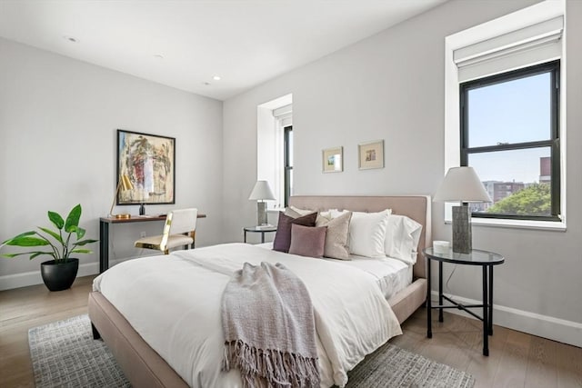 bedroom with recessed lighting, baseboards, and wood finished floors