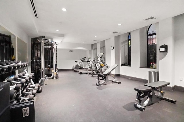 exercise room with recessed lighting, visible vents, and baseboards