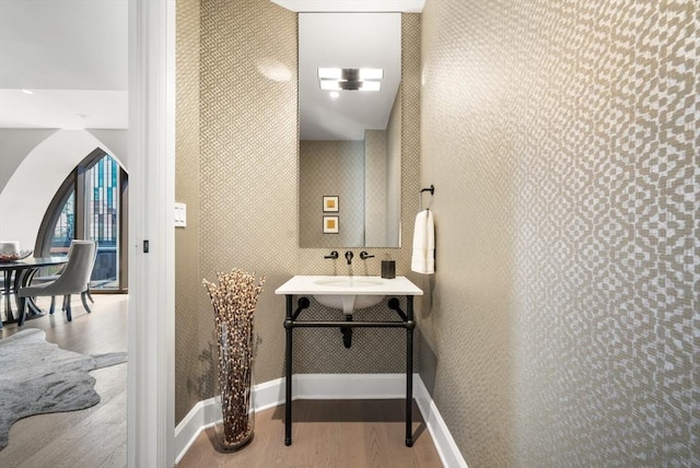 bathroom with wood finished floors and baseboards