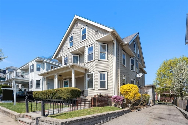 view of front of home featuring fence