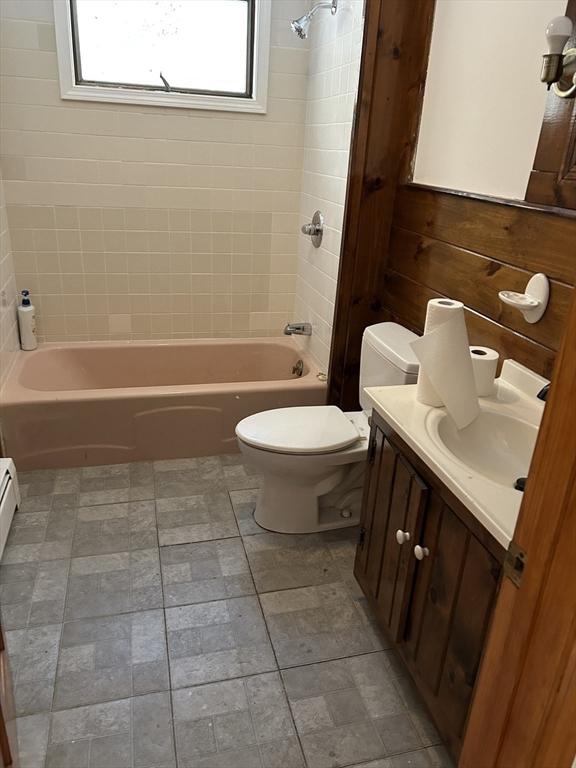 full bathroom featuring vanity, toilet, and tiled shower / bath